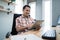 Business owner relaxing using tablet at his office