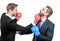 Business partners competitors fight with boxing gloves in formalwear isolated on white, competition