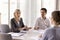 Business partners gather together in modern office boardroom