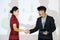 Business partners shaking hands after concluding a business presentation finished. Business man and woman standing in front of