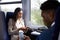 Business Passengers Sitting In Train Commuting To Work Looking At Mobile Phones