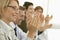 Business People Applauding At Conference Table