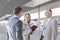 Business people conversing on train platform