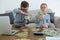 Business people counting currency while sitting on sofa