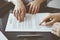 Business people discussing contract signing deal while sitting at the glass table in office, closeup. Partners or