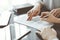 Business people discussing contract signing deal while sitting at the glass table in office, closeup. Partners or