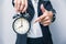 Business people hand finger pointing at clock times at 8 o`clock, reminder time to do something or timing notice concept