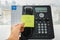 Business people hand place sticky note with call back message on office IP phone
