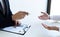 Business people hold resume documents, interviews for the work experience of young men applying as financial accountants for the c