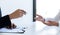 Business people hold resume documents, interviews for the work experience of young men applying as financial accountants for the c