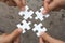 Business people Holding Jigsaw Puzzle, group of business people using a jigsaw puzzle to demonstrate the need to work in the same