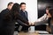 Business people join punching fists bump hands as team their meeting