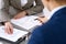 Business people and lawyer discussing contract papers sitting at the table, closeup view