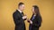 Business people man and woman cute talking against yellow background