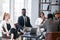 Business people in multiracial meeting sitting in modern office