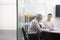 Business People Reviewing Documents At Table