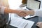 Business people shaking hands above contract papers just signed on the white table, closeup. Lawyers at meeting