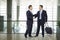 Business people shaking hands at airport