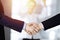 Business people shaking hands at meeting or negotiation, close-up. Group of unknown businessmen and a woman stand