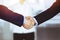 Business people shaking hands at meeting or negotiation, close-up. Group of unknown businessmen and a woman standing in