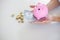 Business people sheltering coins and piggy bank at desk. saving