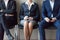 Business people sitting in chairs in queue waiting job interview