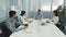 Business people sitting at conference table. Confident arabic businessman talking to colleagues or partners, male leader