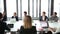 Business people sitting at table in conference room and listening presentation