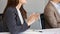 Business people sitting by working table at conference. Selective focus at businesswoman`s hands clapping at the meeting. Success