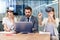 Business people using virtual reality goggles during meeting. Team of developers testing virtual reality headset and