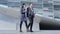 Business people walking and talking - business woman and business man outside