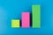Business performance chart with multicolored bars with rise dynamic against blue background