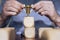 Business person arranging large wooden blocks with a winning trophy. Business success