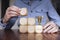 Business person arranging large wooden blocks with a winning trophy. Business success