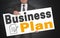 Business plan poster is held by businessman