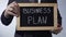 Business plan written on blackboard, male hands holding sign, strategy, goals