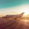 Business plane at airport with sun rays