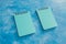 Business planning concept, couple of matching blue notepads on blue background