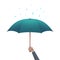 Business protection concept. Businessman hand holding umbrella under dripping rain