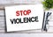 Business quotes, STOP VIOLENCE on notebooks or paper in office desk