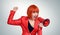 Business redhead woman in red screaming into a megaphone