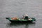 Business on rowboat in the Halong Bay of Vietnam