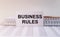 Business rules inscription on paper on office table, top view