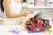 Business, sale and floristry concept - close up of florist woman holding bunch at flower shop. Soft shades of fresh  flowers