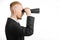 Business and search topic: Man in black suit holding a black binoculars in hand on white isolated background in studio