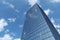 Business skyscraper under blue sky with clouds