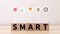 Business and SMART symbol. Wooden blocks with words `SMART,