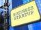 Business Startup. Signpost on Blue Background.
