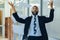 Business stress overwhelmed African American businessman throwing papers in the air office