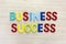 Business success in multicolor on wooden table